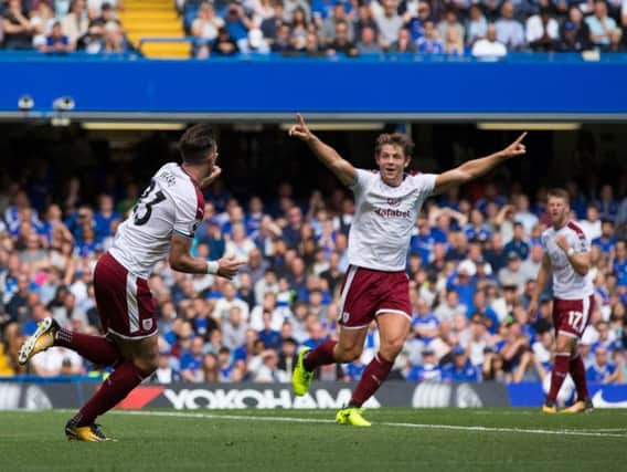 Stephen Ward wheels away in celebration after scoring for the Clarets against Chelsea at Stamford Bridge.