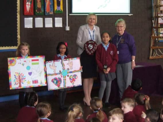 Alessandra is pictured with her trophy with Mrs Price holding the shield which she received from Jackie Seed. Alisha Rooney and Erin Lampitco, who were runners up in the Burnley competition are pictured with their designs.