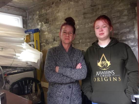 Tracey and her daughter Demi in the outhouse that was destroyed by a fire in their tumble dryer.