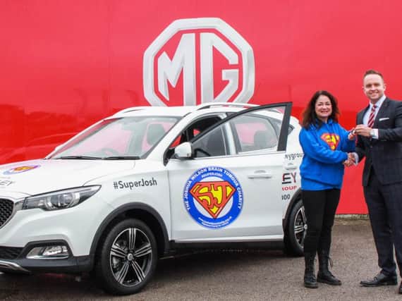 Dawn Fidler, founder of the SuperJosh charity, and Adam Turner, Sales Director for Chorley Group, with the new SuperJosh MG ZS.