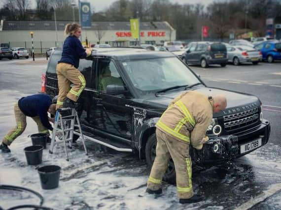 Firefighters hard at work during the charity car wash in Padiham