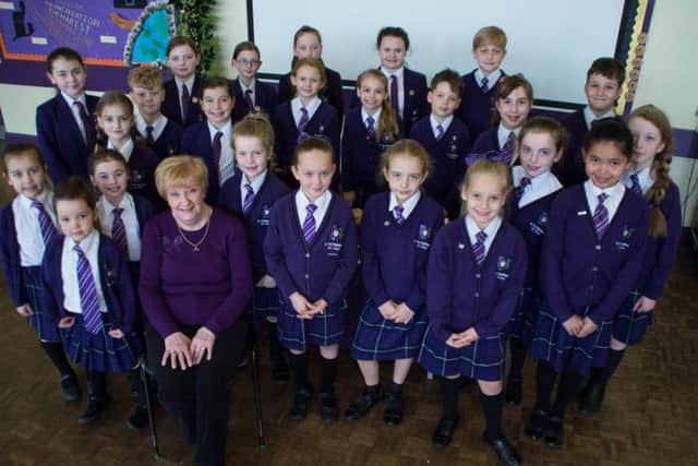 Mrs White, surrounded by pupils at St Mary Magdalene's RC Primary School in Burnley, where she is retiring from after 42 years.