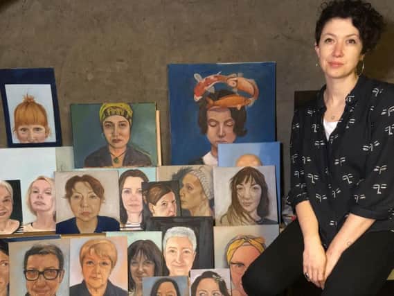 Lucy Gordon with a selection of her portraits.