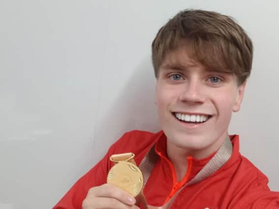 Former Burnley Bobcat Tom Hamer proudly displays his gold medal after a record-breaking swim. Credit: Swim England.
