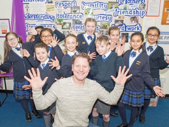 Opera singer Sean Ruane with pupils at St Joseph's Park Hill School, Burnley. (s)