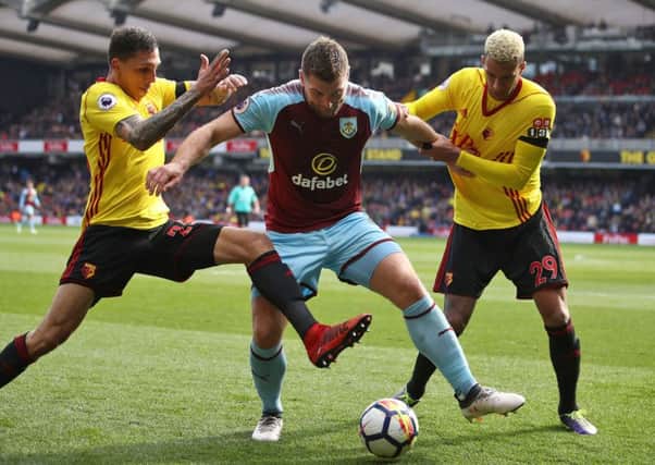 Burnley's Sam Vokes (centre) battles with Watford's Jose Holebas (left) and Etienne Capoue during the Premier League match at Vicarage Road, Watford. PRESS ASSOCIATION Photo. Picture date: Saturday April 7, 2018. See PA story SOCCER Watford. Photo credit should read: John Walton/PA Wire. RESTRICTIONS: EDITORIAL USE ONLY No use with unauthorised audio, video, data, fixture lists, club/league logos or "live" services. Online in-match use limited to 75 images, no video emulation. No use in betting, games or single club/league/player publications.