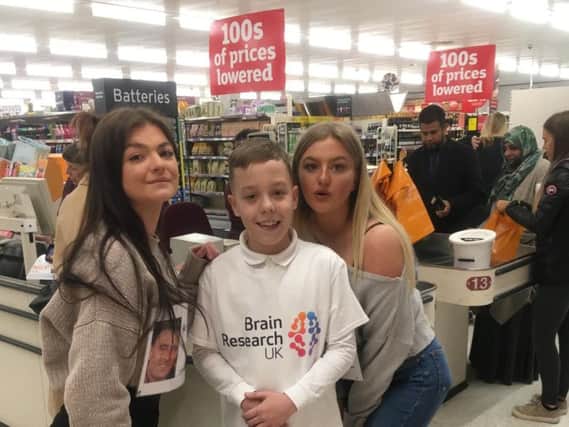 Keira's daughters Tia (far left) and Honey (far right) with Damian's son Henry at the bag-packing event in Sainsbury's.