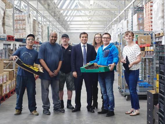 Recycling Lives' Group MD, William Fletcher (centre), with the team at the Food Redistribution Centre.