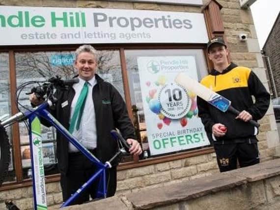 Cricketer Bailey is presented with his bike by Andrew Turner, managing director of Pendle Hill Properties.
