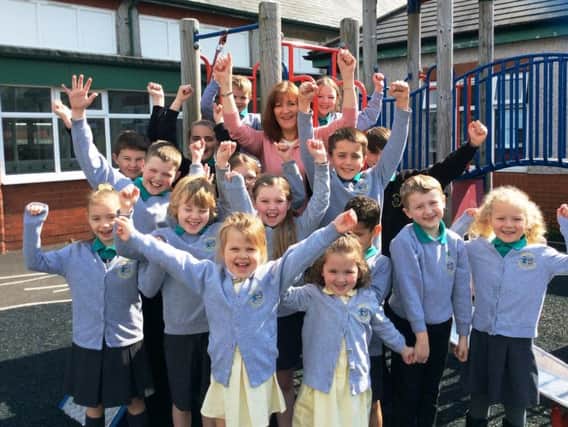 Mrs Marney and some of her pupils celebrate the recent Ofsted report at Ightenhill Primary School in Burnley.