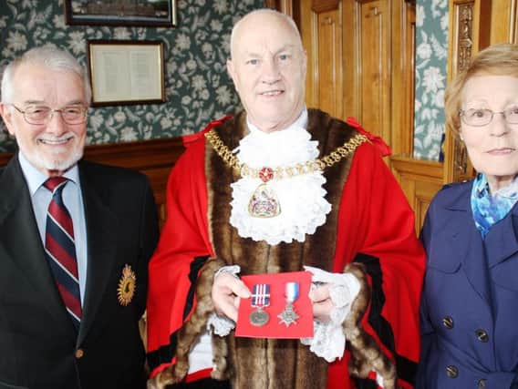 Mr and Mrs Freeman presenting Pte Henry Smiths Military Medal and Bar to the Mayor of Burnley Coun. Howard Baker