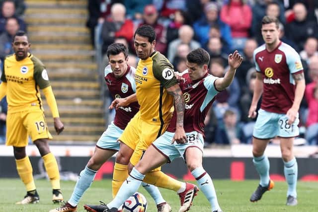 Ashley Westwood vies for possession with Brighton & Hove Albion's Leonardo Ulloa