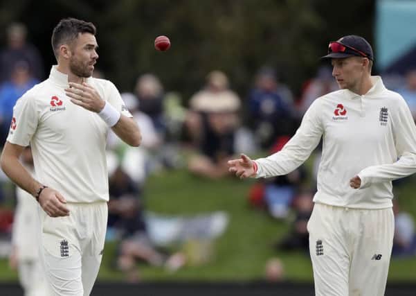England's Joe Root throws the ball to his bowler James Anderson, left, during play on day four of the second cricket test against New Zealand at Hagley Oval in Christchurch, New Zealand, Monday, April 2, 2018. (AP Photo/Mark Baker)
