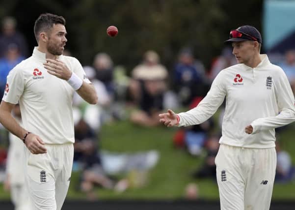 England's Joe Root throws the ball to his bowler James Anderson, left, during play on day four of the second cricket test against New Zealand at Hagley Oval in Christchurch, New Zealand, Monday, April 2, 2018. (AP Photo/Mark Baker)
