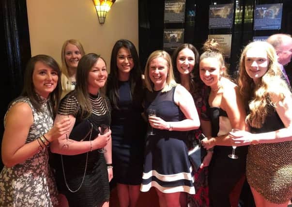 Sam Quek MBE pictured with members of Pendle Forest's award-winning hockey team