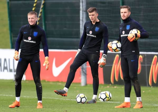 England goalkeepers Jordan Pickford (left), Nick Pope (centre) and Jack Butland during the training session at St George's Park, Burton. PRESS ASSOCIATION Photo. Picture date: Tuesday March 20, 2018. See PA story SOCCER England. Photo credit should read: Mike Egerton/PA Wire. RESTRICTIONS: Use subject to FA restrictions. Editorial use only. Commercial use only with prior written consent of the FA. No editing except cropping.