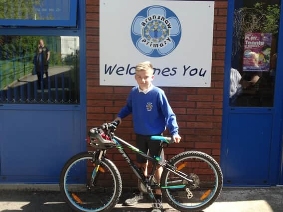Lucky Cameron Halstead with the star prize of a bike he won as part of the "Active Ants" project.