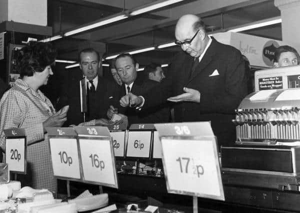 On the day of the official change to decimalised currency, Lord Fiske, chairman of the Decimal Currency Board, makes a purchase at a Woolworths store (Photo: George W. Hales/Fox Photos/Getty Images)